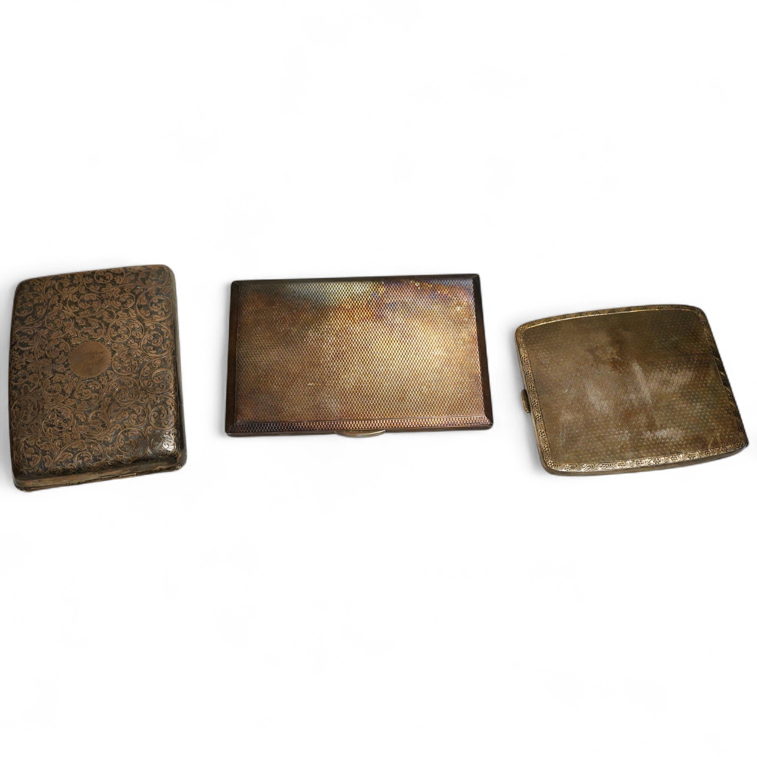 Two George V silver cigarette case, one foliate engraved Birmingham, 1912 the other folaite engraved Birmingham, 1919 Willaim Neale Ltd and a George VI engine turned cigarette case, weight approx. 14.43ozt (3)